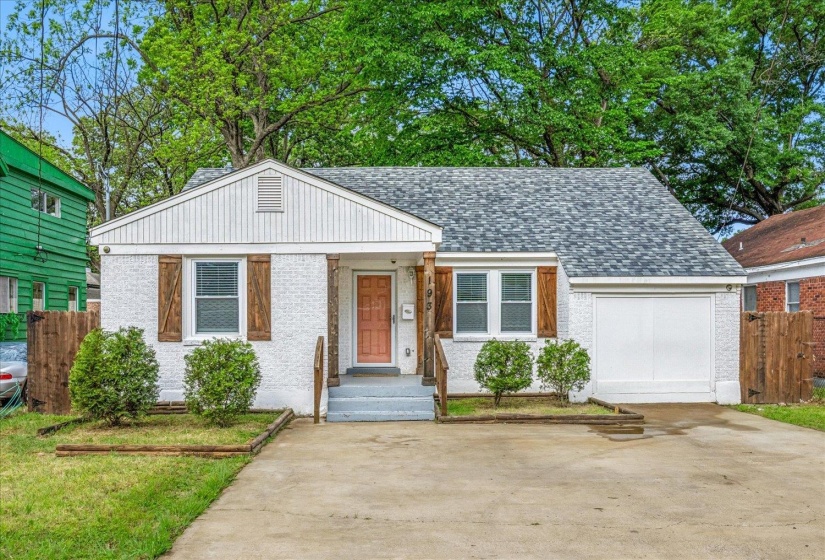 White brick exterior featuring a covered entry, wood-finish columns, a single-car garage, and a shingled roof