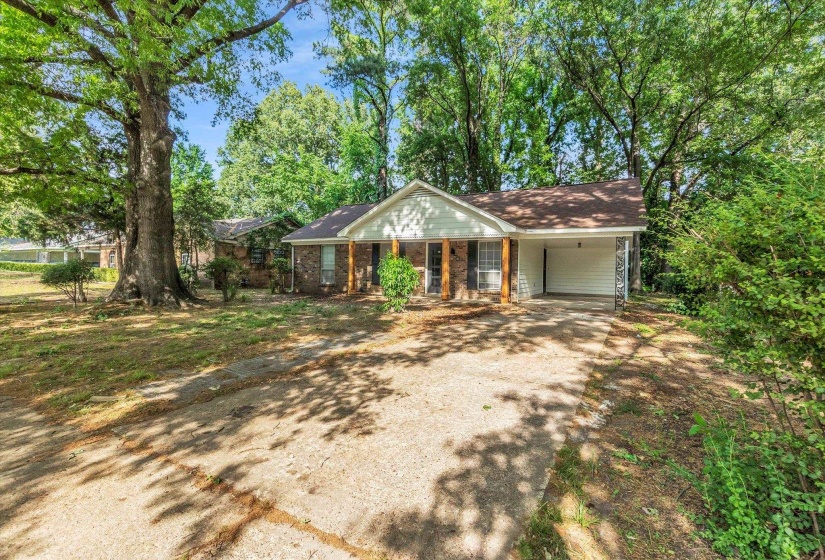 Ranch-style residence featuring a brick facade and white siding