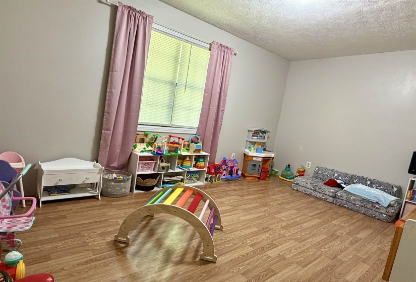 Bright room featuring wood-finish flooring and neutral wall tones