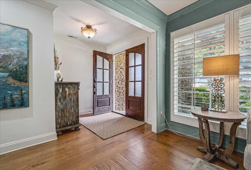 Double entry doors with glass panels and stone veneer surround
