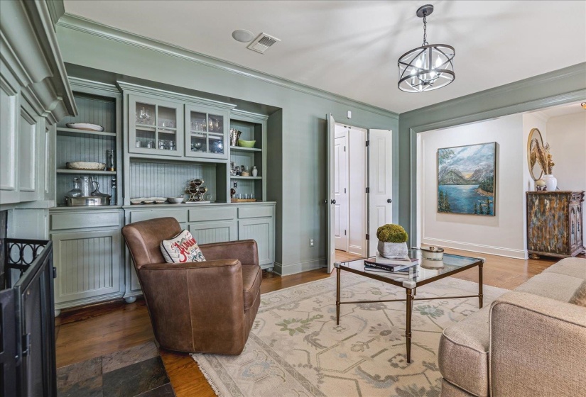 Custom built-in cabinetry with glass-front uppers and beadboard accents