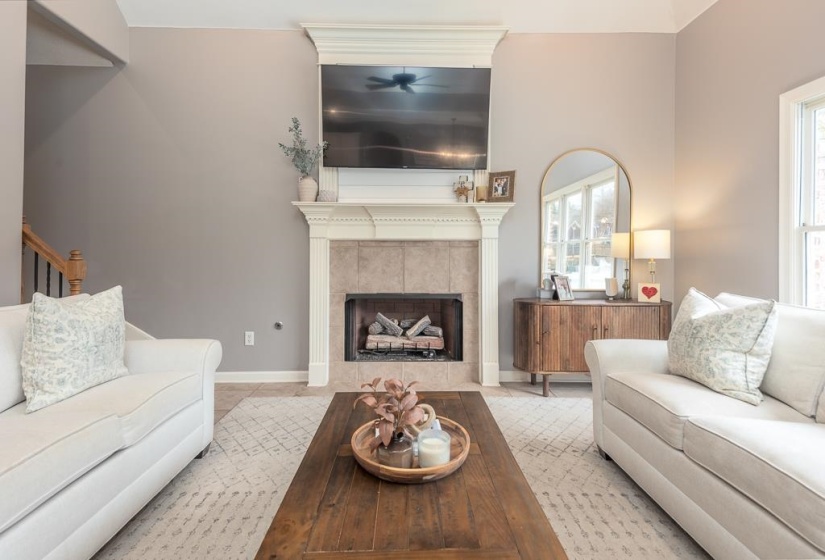 Living area featuring a fireplace with a stone tile surround and a decorative mantel