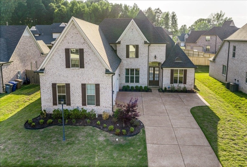 Two-story brick facade residence with gabled roof lines
