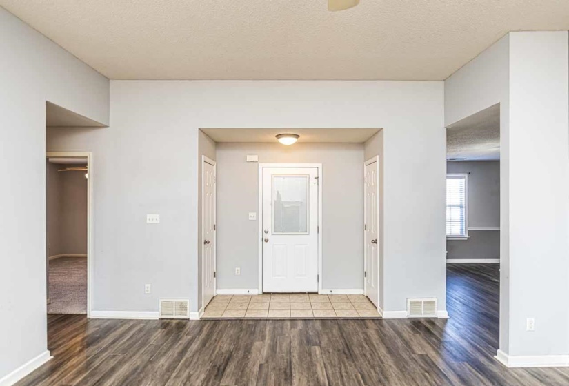 Entryway with a textured ceiling and wood finished floors