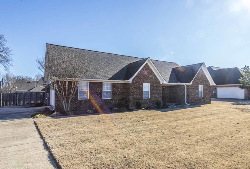 View of front of house with brick siding, roof with shingles, and a garage