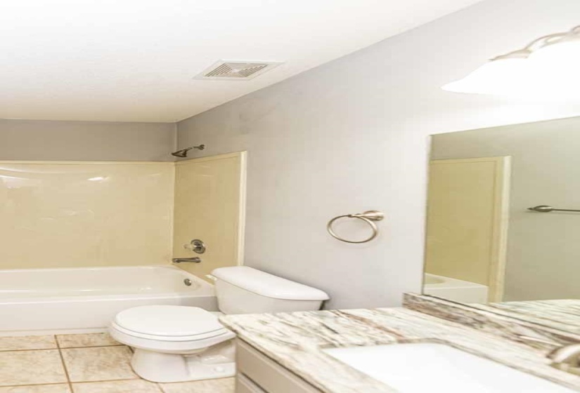 Full bathroom with vanity, shower / bath combination, and light tile patterned floors