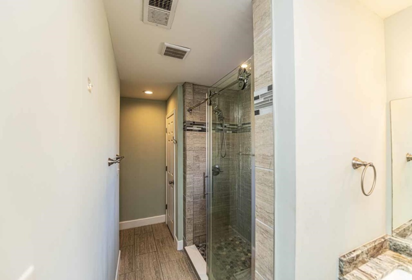Full bath featuring a stall shower, recessed lighting, and vanity
