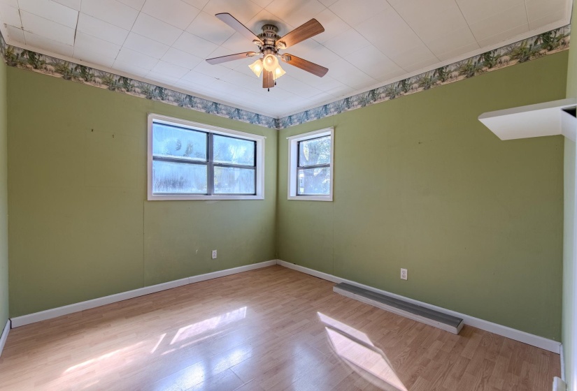 Empty room with wood finished floors and ceiling fan