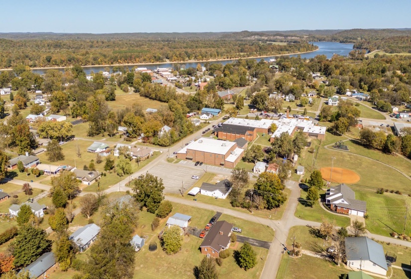 Aerial view of property's location with a nearby body of water and nearby suburban area