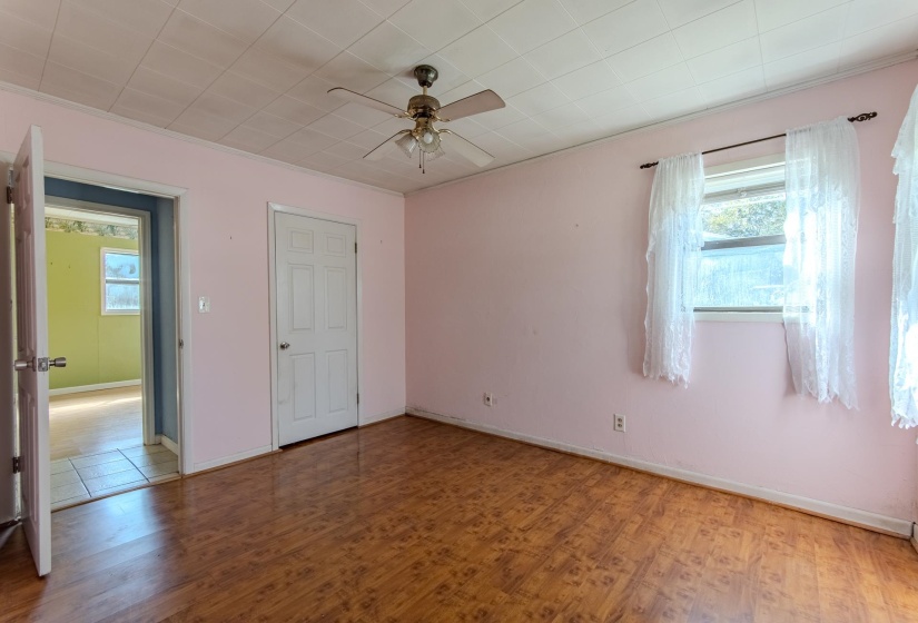 Empty room featuring wood finished floors and a ceiling fan