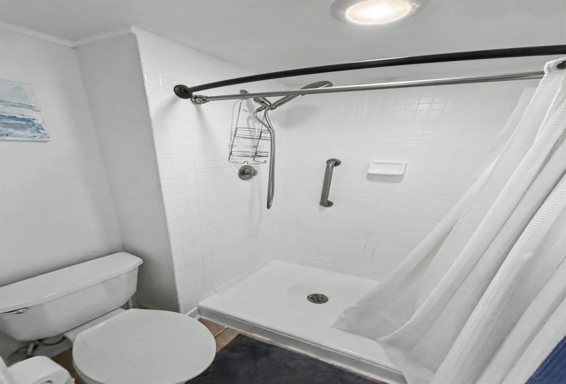 Shower stall with white subway tile surround and a matching white shower pan