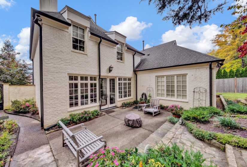 Tranquil private courtyard with mature landscaping and ample patio space, ideal for entertaining, dining al fresco, or relaxing outdoors.