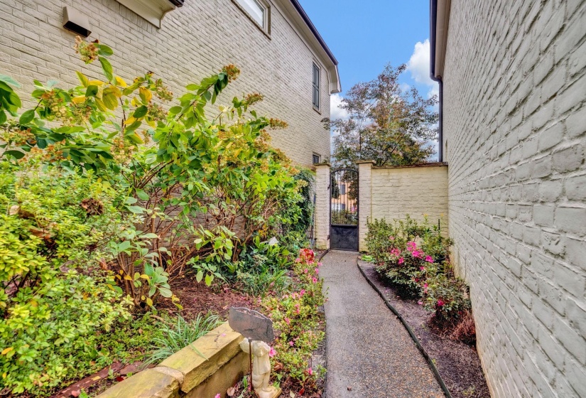Beautifully landscaped private garden path flowing from the drive to the tranquil courtyard.