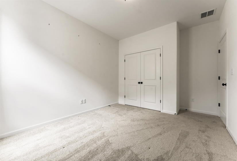 Neutral-toned carpeting anchors this room, complemented by white walls and trim