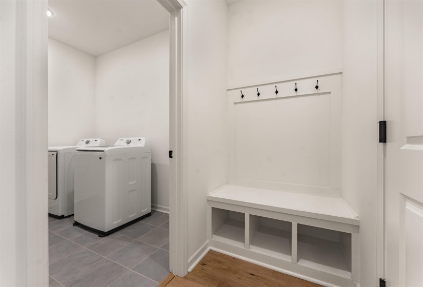 Dedicated laundry area with durable tile flooring