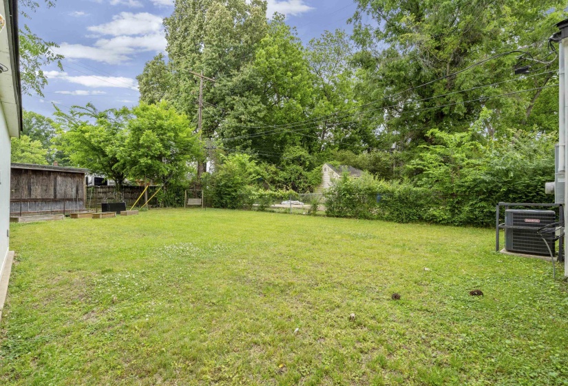 Spacious lawn area with established perimeter landscaping and mature trees