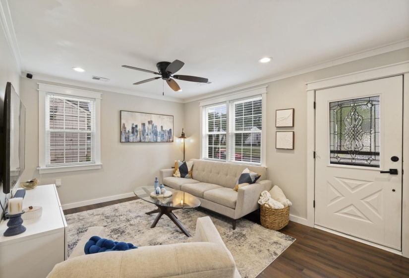 Living area featuring wood-finish flooring, a decorative front door with leaded glass, recessed lighting, and a ceiling fan