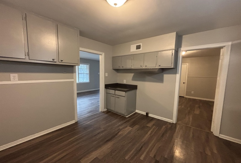 Efficient kitchen space featuring wood-finish flooring, two-tone wall paint, and recessed lighting