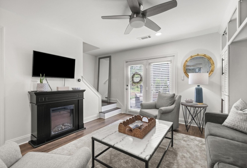 Living space featuring wood-finish flooring, a contemporary ceiling fan, and recessed lighting