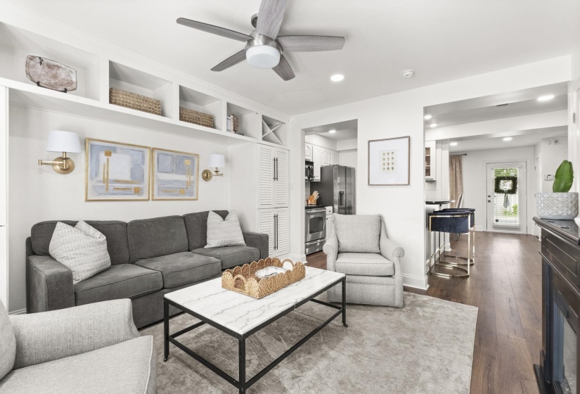 Living area featuring built-in shelving, a ceiling fan, and recessed lighting