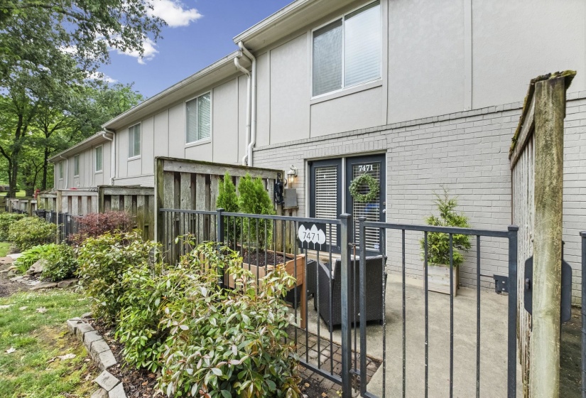 Private patio area featuring a concrete surface and metal fencing