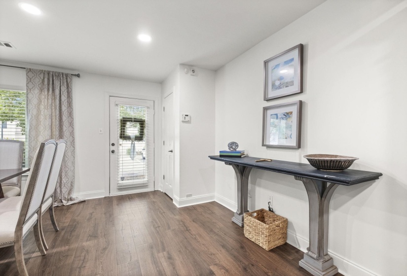 Wood-finish flooring throughout, bright white walls, and recessed lighting