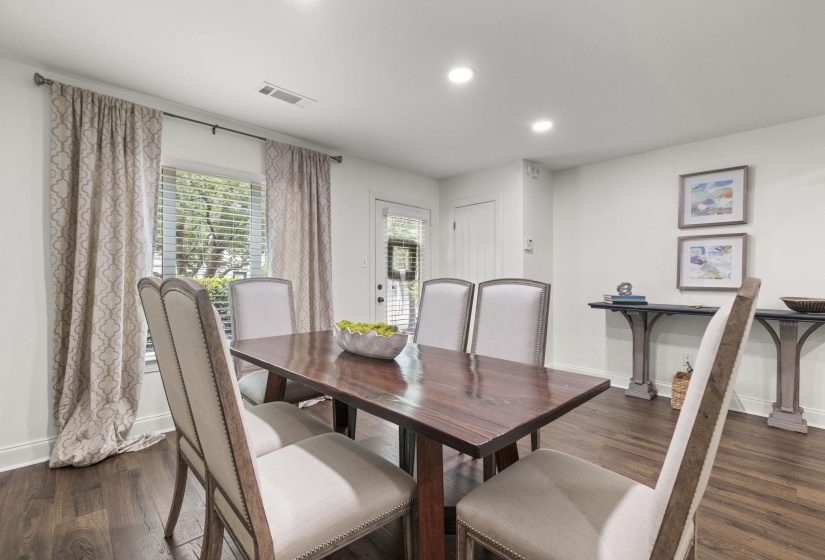 Spacious dining area featuring wood-finish flooring and recessed lighting