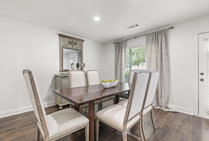 Dining area featuring wood-finish flooring, white baseboards, and a white ceiling with recessed lighting