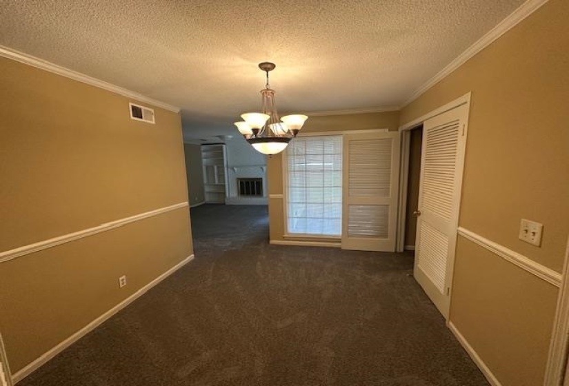Interior space featuring warm-toned walls, white crown molding, and wainscoting