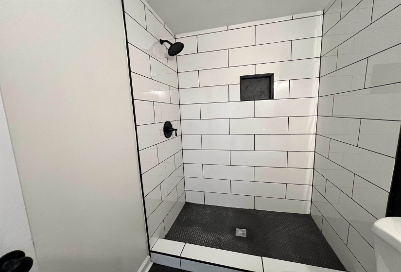Full bathroom with a shower stall and toilet
