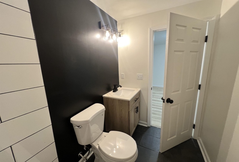 Bathroom featuring vanity and dark tile patterned floors