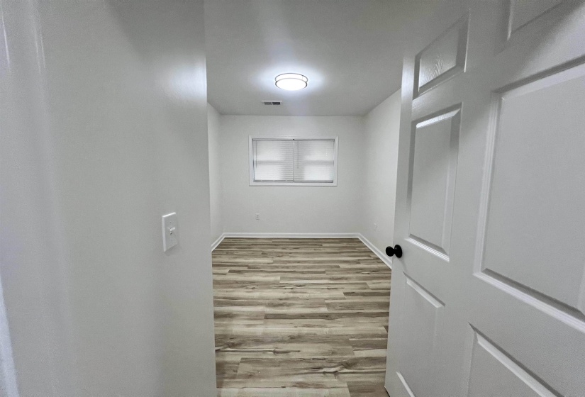 Unfurnished room with light wood finished floors and baseboards