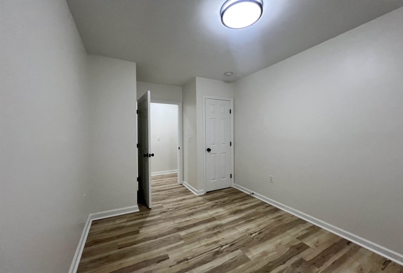 Unfurnished room featuring light wood-style floors and baseboards