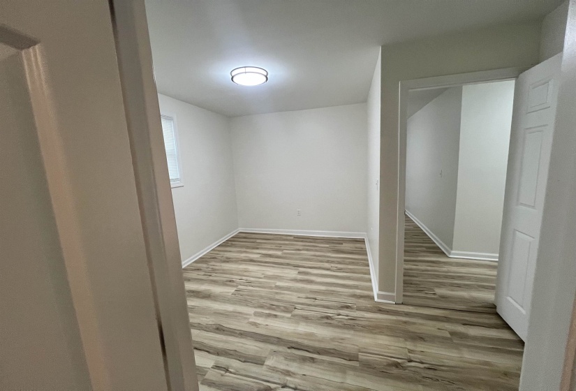 Below grade area featuring light wood-style floors and baseboards