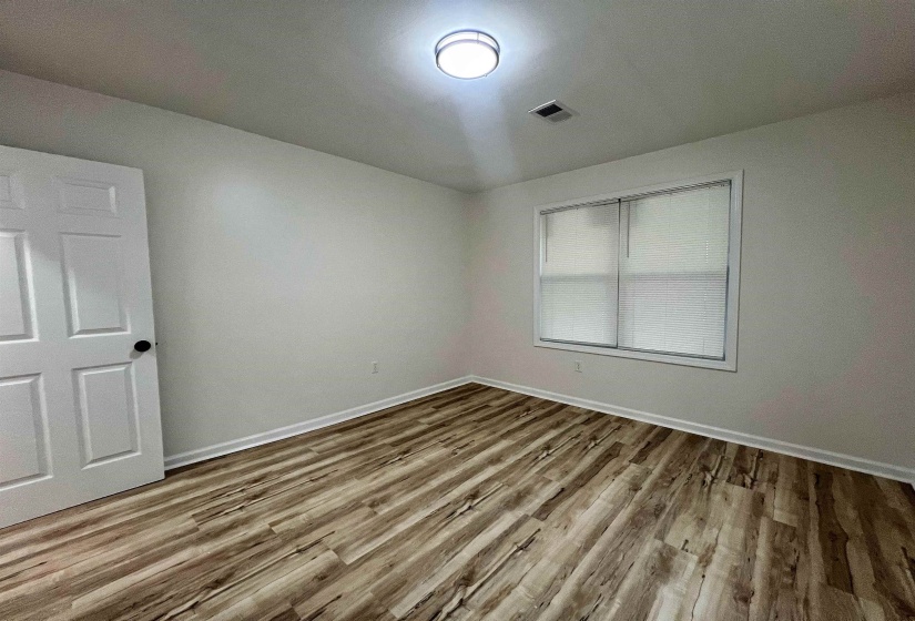 Empty room featuring wood finished floors and baseboards