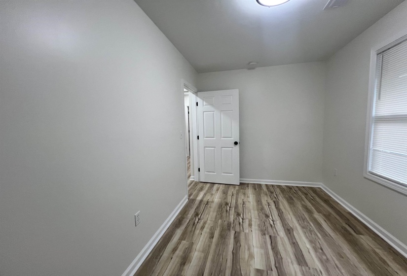 Unfurnished room featuring light wood-style flooring and baseboards