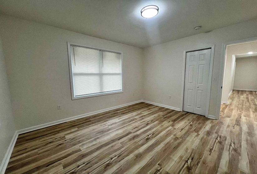 Unfurnished bedroom with light wood-style floors and a closet