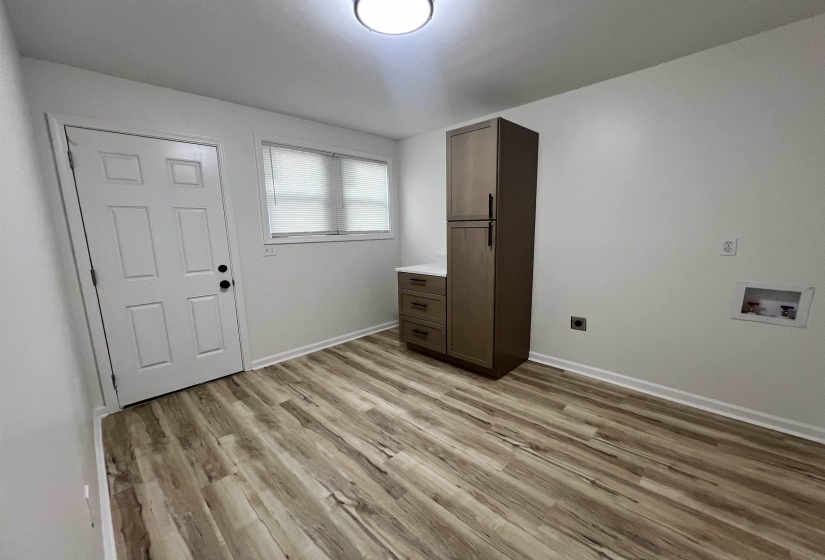 Foyer featuring light wood finished floors and baseboards