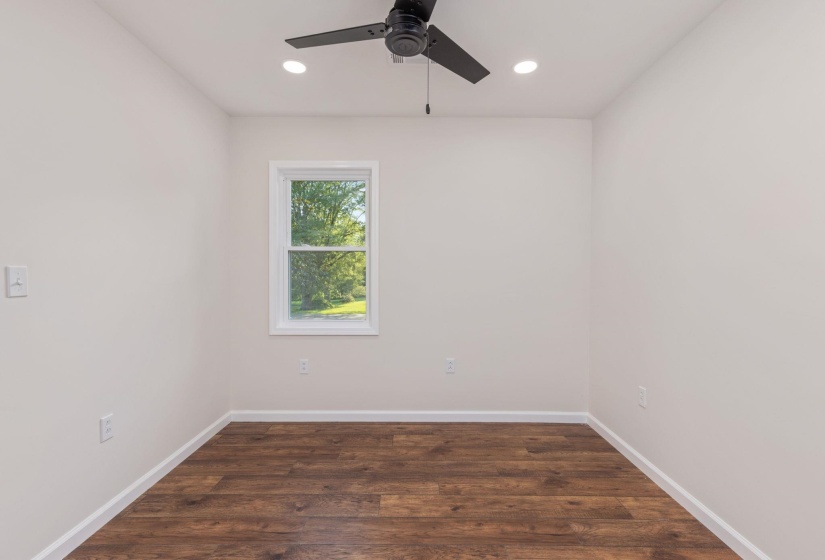 Empty room featuring a ceiling fan, recessed lighting, and wood finished floors