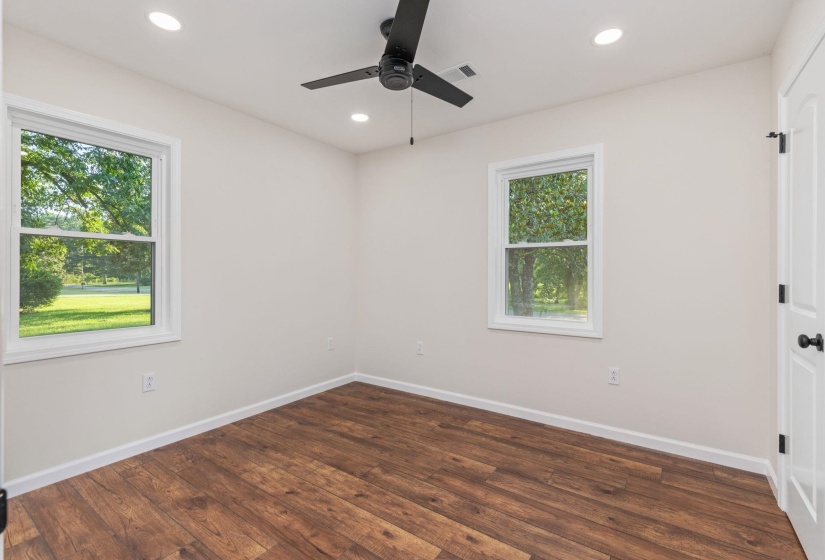 Unfurnished room with healthy amount of natural light, ceiling fan, wood finished floors, and recessed lighting