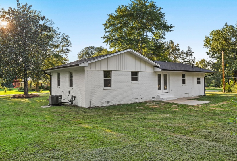 Back of property with crawl space, french doors, brick siding, a yard, and entry steps