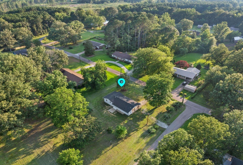 Aerial overview of property's location featuring a heavily wooded area
