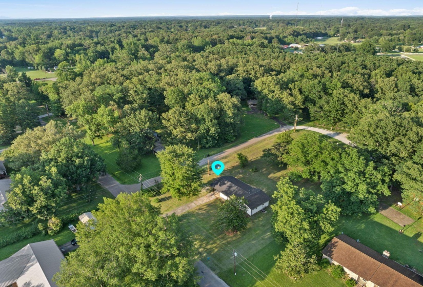 Aerial view of property's location featuring a forest