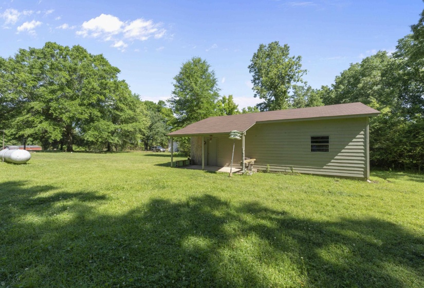 Detached auxiliary building with horizontal siding and a covered entry
