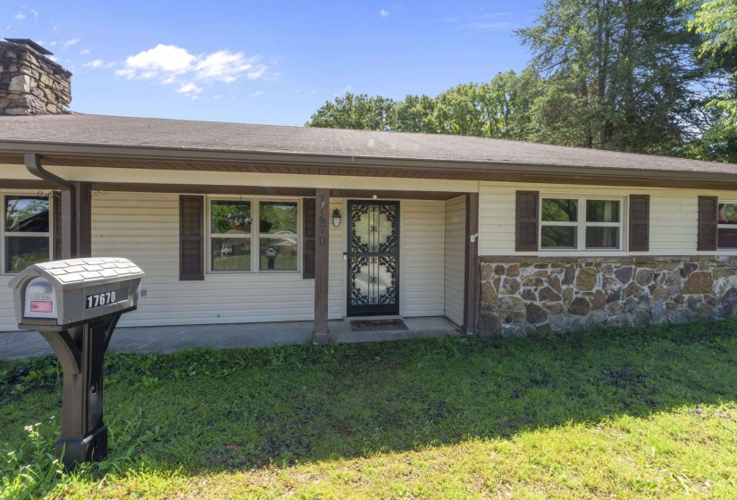 Ranch-style exterior with stone veneer and horizontal siding