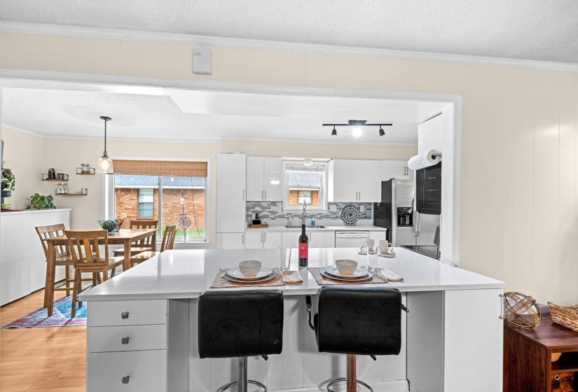 Kitchen featuring a central island with white cabinetry, white countertop, and integrated drawers
