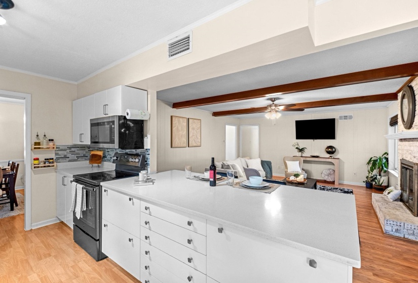 Spacious kitchen island with a white countertop and ample storage