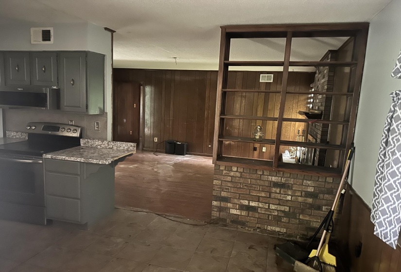 Kitchen featuring gray cabinetry, a black electric range, and granite-style countertops