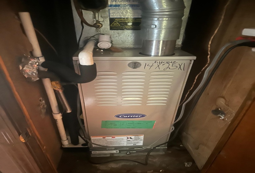 Carrier brand HVAC unit with visible ductwork and piping
