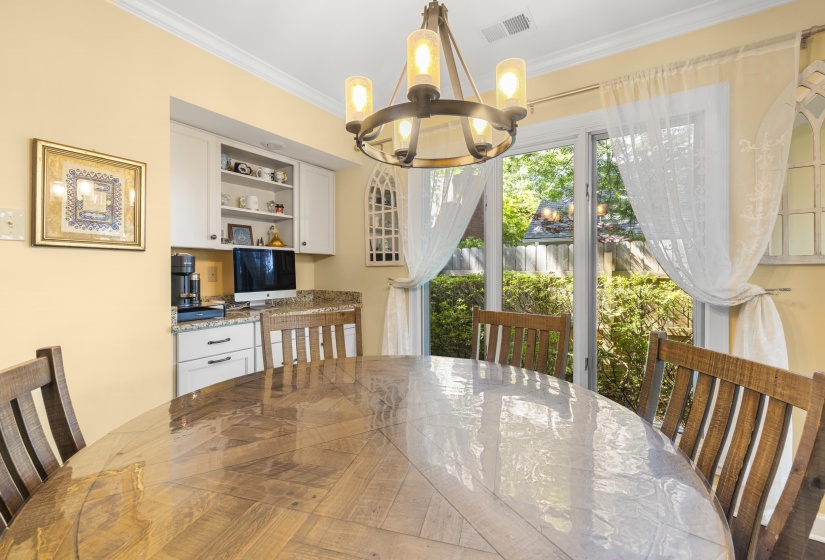 Dining area featuring a wood-finish oval table with a clear protective covering